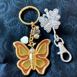 Two Butterfly Keychains - One Silver Tone and One Gold Tone Saying “Believe